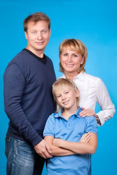 Happy family father, mother and son on a blue background