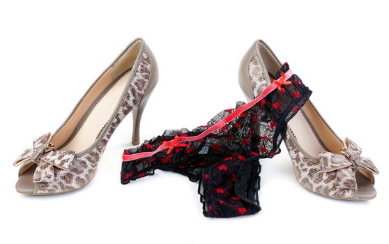 A pair of female leopard shoes with high heels and lace panties