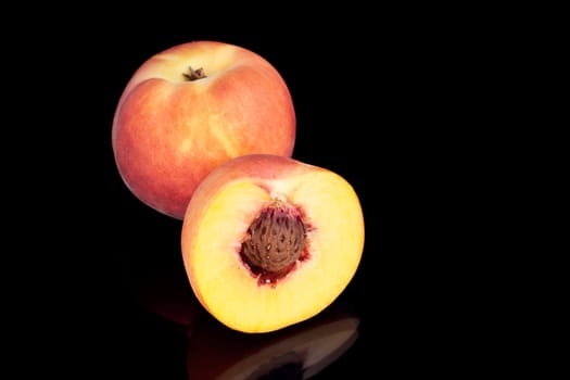 Two fresh peaches image on the black background