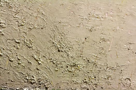 art rough dabs of grey putty on the wall
