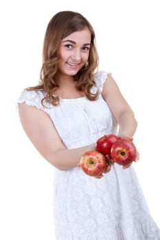 Beautiful young girl with three apples in their hands, isolate white
