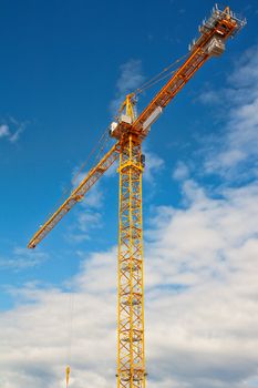 yellow crane and blue sky on building site
