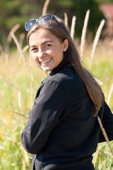 Portrait of a girl in the ears of sunglasses in the setting sun