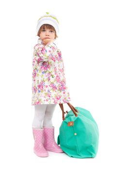 Pretty little girl in autumn clothes with a big bag. Studio portrait of a full-length, isolate on white.