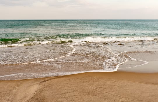 Ocean wave and sandy beach