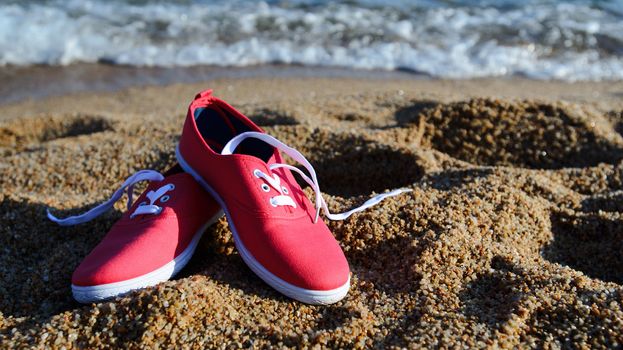 Pair of shoes on a sandy beach