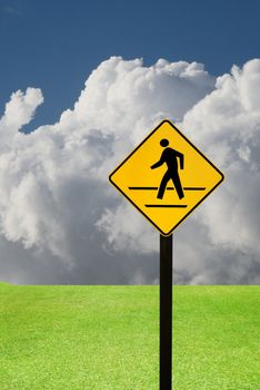 Crosswalk sign with a man walking on yellow with nice landscape