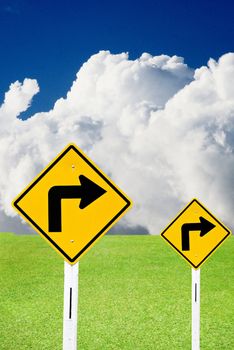 Turn right sign with cloudy sky and nice meadows