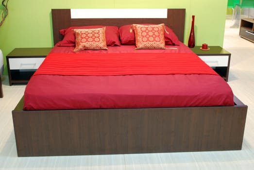 Bedroom with red bed and pillows