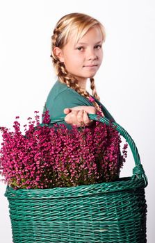 Beautiful girl with a basket of Purple heather flowers