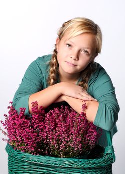 Beautiful girl with a basket of Purple heather flowers