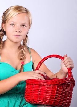 Beautiful girl with a basket of  Apples