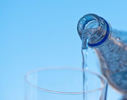 water is pouring down from plastic bottle, image on white background