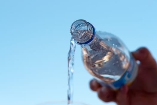 water is pouring down from plastic bottle, image on white background