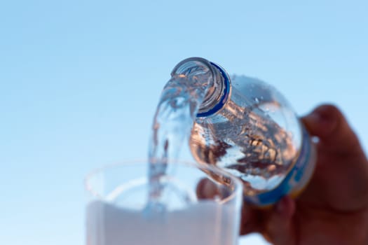 water is pouring down from plastic bottle, image on white background
