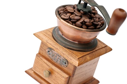 Old coffee grinder with beans