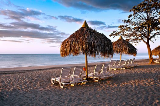 Beautiful  beach  on Pacific ocean with chaise lounge 