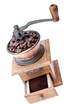 Old coffee grinder with beans