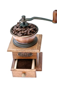 Old coffee grinder with beans