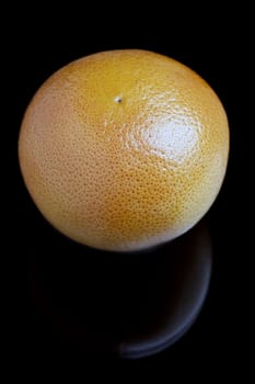 The image of a Fresh grapefruit on black bacground