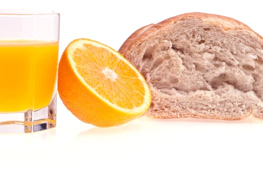 Glass of orange juice,  orange, and bread on white background