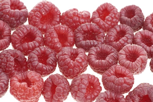 Macro of a stack of raspberries against white background 