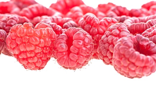 Macro of a stack of raspberries against white background 