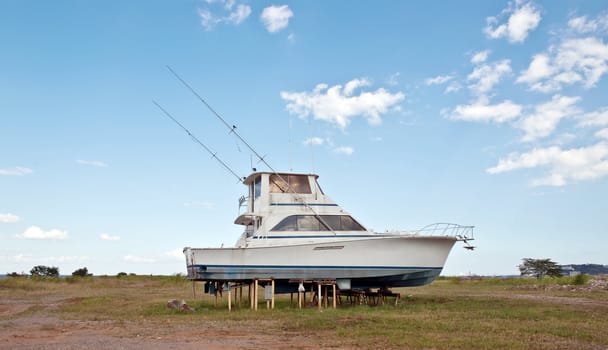 Old recreational boat on the beach 