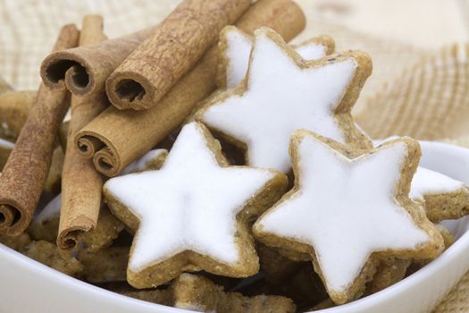 typical christmas cinnamon star cookies and cinnamon sticks