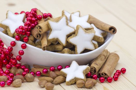 typical christmas cinnamon star cookies, nuts and cinnamon sticks