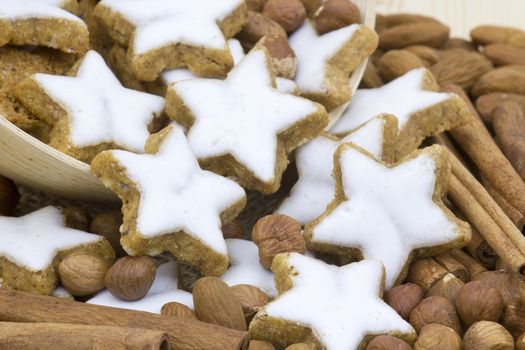 typical christmas cinnamon star cookies, nuts and cinnamon sticks