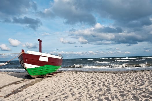 Old fisherman boat on the shore of Baltic sea