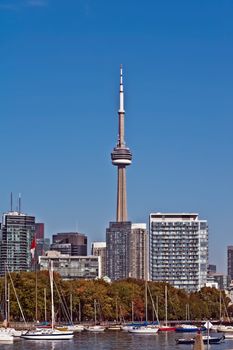blue panoramic skies above Toronto CN Tower overlooking the luxury high rise apartments along the harbour waterfront of Lake Ontario, Toronto, Canada.
