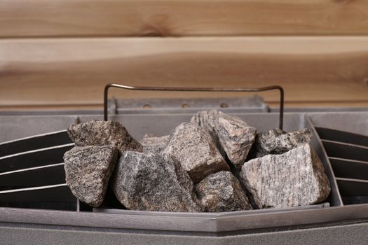 rocks on a sauna heater in a wooden cabin producing heat
