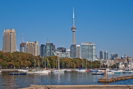 blue panoramic skies above Toronto CN Tower overlooking the luxury high rise apartments along the harbour waterfront of Lake Ontario, Toronto, Canada.