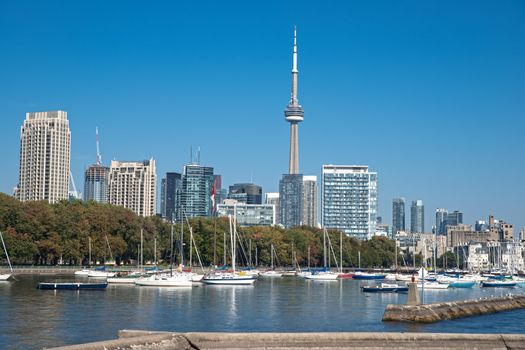 blue panoramic skies above Toronto CN Tower overlooking the luxury high rise apartments along the harbour waterfront of Lake Ontario, Toronto, Canada.