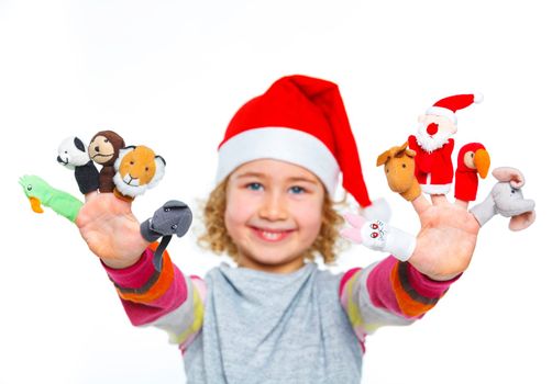 Cute and happy girl in Santa's hat playing with finger puppets, isolated on white. Focus on the finger puppets.