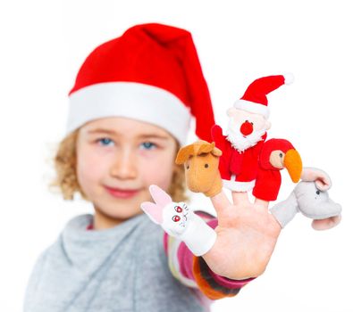 Cute and happy girl in Santa's hat playing with finger puppets, isolated on white. Focus on the finger puppets.