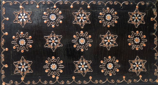 Carved flowers on wooden background