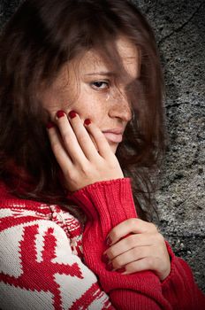 Sad woman crying, hair flying, dark background