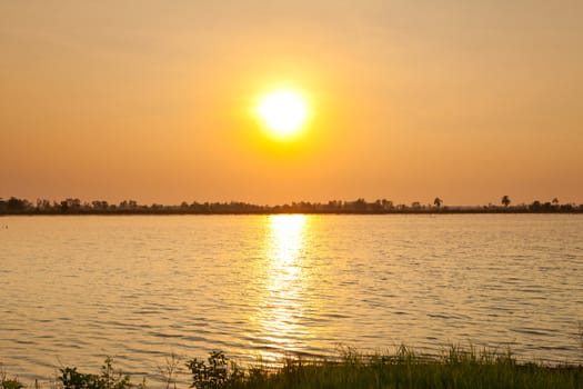 beautiful Summer lake and orange sky on sunset