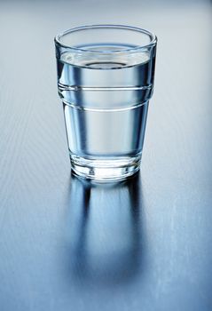 Pure water in glass on a table, shallow focus