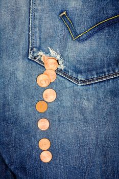 Money fall down from a hole in jeans pocket