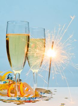 Two glasses of champagne with ribbons and burnning sparkler