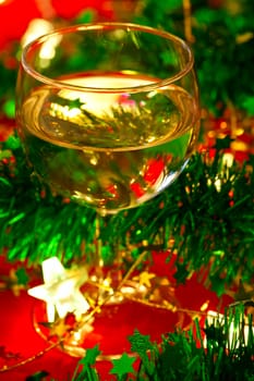 Glass of white wine with Christmas decoration, very shallow DOF