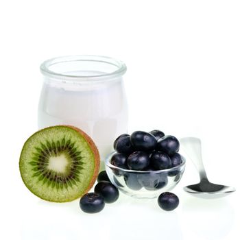 Old-fashioned yogurt jar and fruits on white background