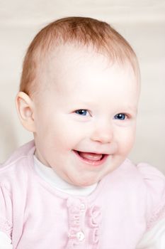 Portrait of cheerful blue-eyed baby girl