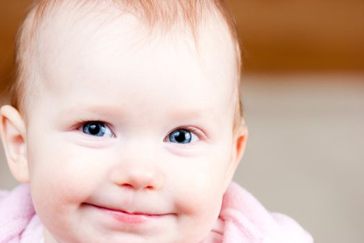 Portrait of cheerful blue-eyed baby girl