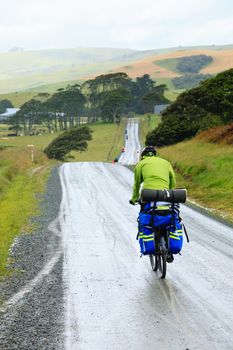 Cycle tourists on a dirt road in New Zealand