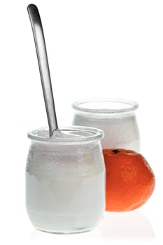 Old-fashioned yogurt jars with tangerine on white background